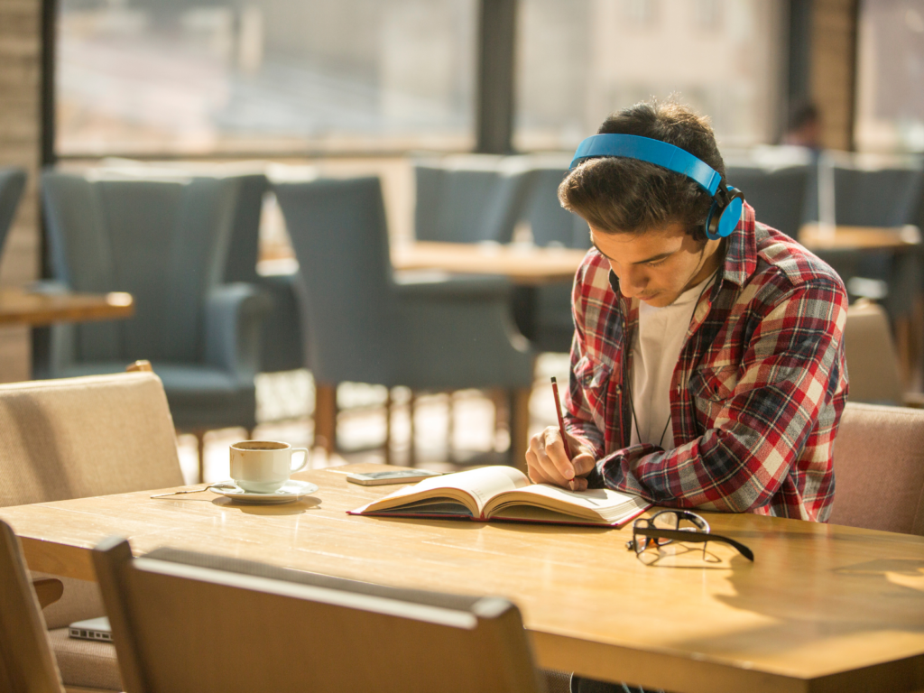 Student studying with noise-canceling headphones